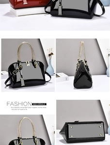 Detail view of black patent leather Boston bag with gold braided handle and metal studs