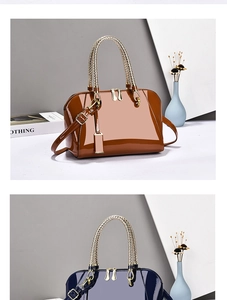 Glossy patent leather boston bag featuring unique woven metal handles and dual zipper detail