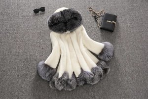 Detailed flat lay of cream faux fur coat with grey trim, sunglasses and a chain bag