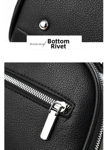 Detail of silver bottom rivets and metal zipper on black lychee grain leather tote bag