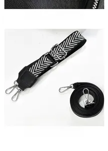 Detail of wide woven strap and thin leather shoulder strap with back zipper pocket