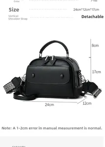 Detailed view of black pebbled leather bag with size dimensions 24x12x17cm and wide strap
