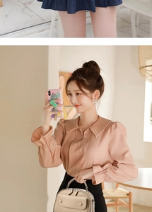 Detail of soft pink chiffon shirt sleeve with elegant ruffles and a beige tote bag