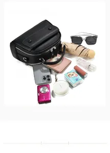 Spacious black leather bag layout showing phone, camera, and daily essentials storage