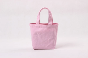 Detail showing the pink canvas fabric texture and sturdy double handles of the mini tote