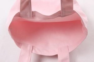 Close-up view showing the interior space and durable canvas texture of the pink bento bag