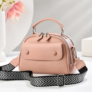 Pink lychee texture Boston handbag with wide chevron strap and silver hardware accents