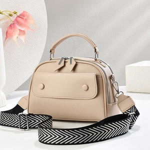 Elegant beige pebbled leather tote bag with stylish herringbone patterned wide strap