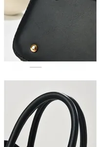 Detail of golden bottom rivets and sturdy handles on a black crocodile pattern handbag