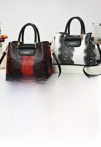 Detail of embossed crocodile pattern handbag with elegant metallic handle attachments
