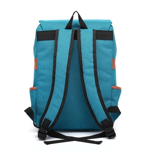 Rear view of blue canvas backpack featuring adjustable black straps and leather accents