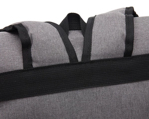 Close-up of durable woven fabric texture and reinforced strap stitching on canvas backpack