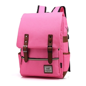 Detail of pink canvas backpack with brown faux leather straps and metal buckles