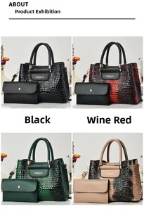 Detail view of crocodile pattern faux leather handbag set with polished metal hardware