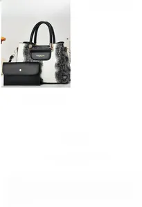 Detail of white crocodile pattern tote bag set with interior compartments and gold hardware
