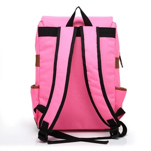 Rear view of pink canvas travel backpack featuring black straps and brown leather accents