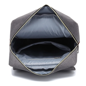 Internal view of gray canvas travel backpack featuring a laptop compartment and zip pocket