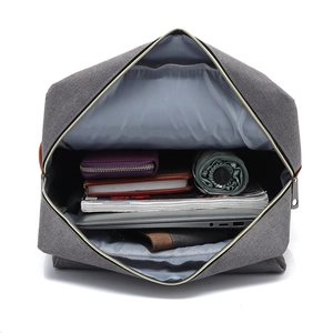 Top view showing the spacious main compartment and interior capacity of the grey canvas backpack