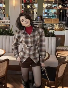 Detail of a vintage plaid long sleeve shirt with coffee and beige checkered pattern
