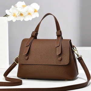 Stylish brown pebble leather saddle bag with gold hardware and top handle for women