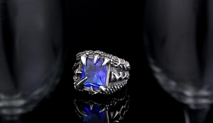 Detailed view of retro dragon claw ring featuring a rectangle blue zircon stone
