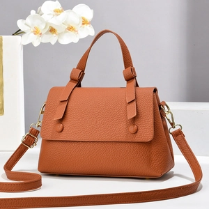 Chic brown lychee grain leather saddle bag with gold hardware and removable shoulder strap