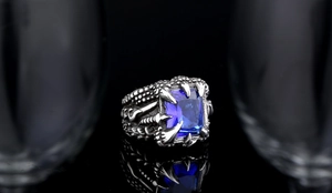 Macro shot of gothic dragon claw ring featuring a large blue rectangular zircon stone