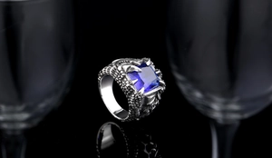 Macro shot of a vintage gothic dragon claw ring with a square navy blue zircon stone