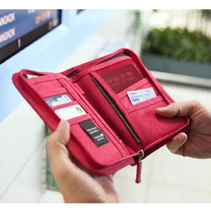 Waterproof travel passport wallet in red fabric with multiple card slots and zip closure