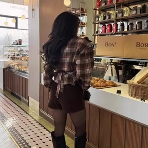 Women's brown plaid long sleeve shirt with back bow tie-up waist design shown from behind