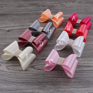 Macro view of assorted chiffon flower hair clips with rhinestones on a wooden background