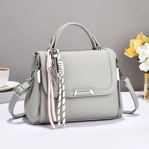 Elegant light gray lychee grain leather handbag with abacus charm and crossbody strap