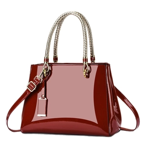 Classic bright red patent leather handbag with gold woven handles and adjustable shoulder strap