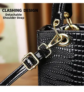 Macro shot of black crocodile embossed leather handbag with gold-tone metal hardware