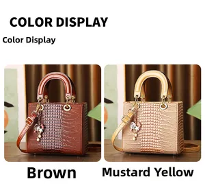 Detail of brown and ginger yellow handbags with crocodile embossed texture and metal charms