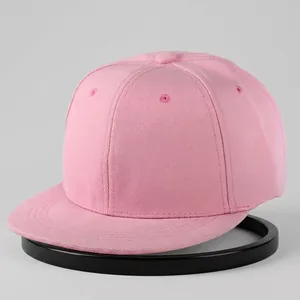 Detailed view of pink flat brim snapback hat showing cotton twill fabric and stitching