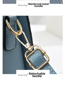 Détail de la quincaillerie dorée et de la poignée en cuir bleu du sac à main