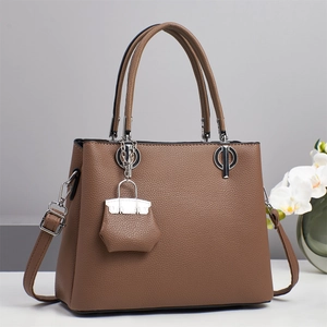 Classic dark brown lychee leather tote bag with round handles and adjustable strap