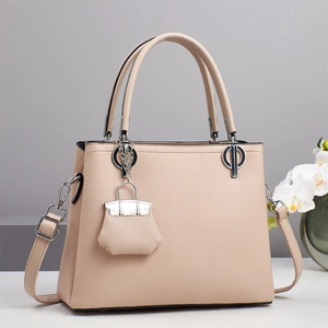 Elegant beige pebbled leather handbag for women with silver hardware and shoulder strap