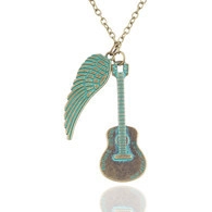 Detail view of vintage bronze necklace featuring guitar and feather wing charms with turquoise finish