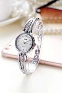 Silver quartz watch for women with rhinestone-studded strap in an elegant lifestyle scene