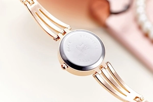 Detailed macro view of the rose gold stainless steel watch back case and engraved model number