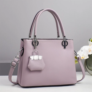 Detail of lavender litchi grain leather handbag with silver hardware and mini charm