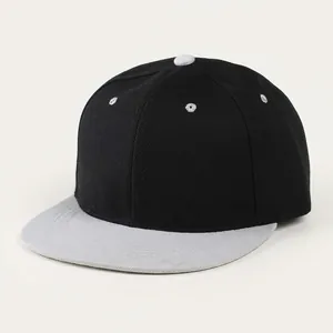 Detail view of a black cotton twill baseball cap featuring a flat white brim and top button
