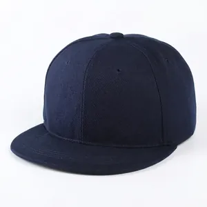 Detailed close-up of navy blue flat brim snapback cap in premium twill cotton fabric