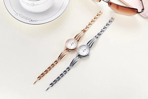 Close-up of rose gold and silver rhinestone steel watches with quartz movement dials