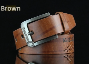 Detailed close-up of brown textured leather belt with gunmetal needle buckle and studs