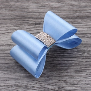 Close-up of light blue satin ribbon hair clip with sparkling rhinestone centerpiece
