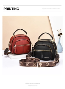 Detail showing litchi leather texture, multi-layer zippers, and wide floral shoulder strap