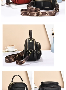 Detail view of black lychee leather crossbody bag with dual zippers and gold hardware